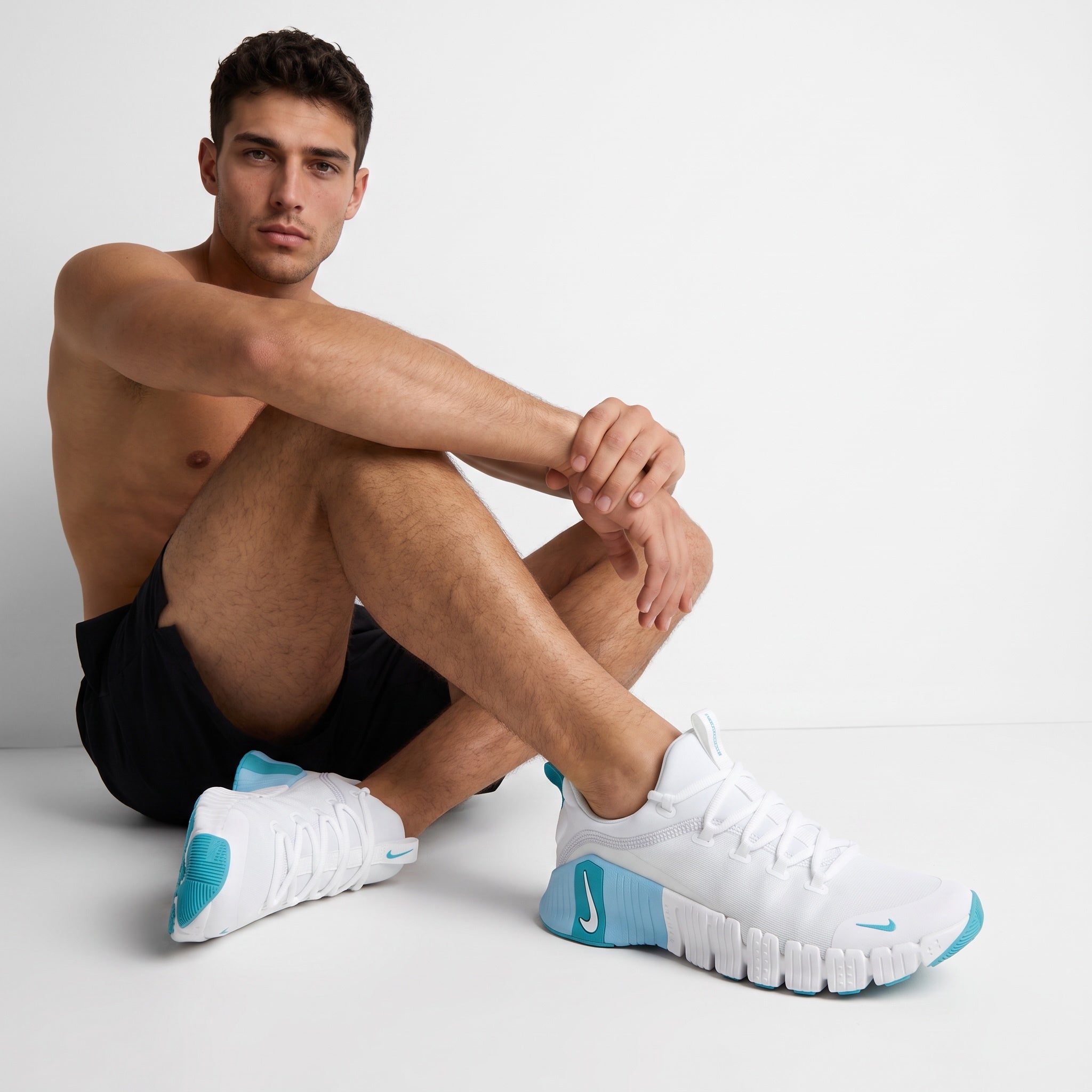 white Nike sneakers with teal accents and segmented sole