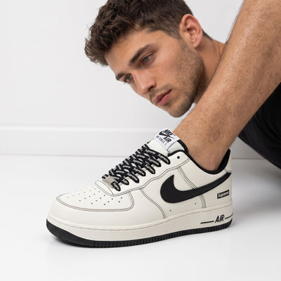 Nike Air Force 1 Low white with black swoosh and Supreme-branded laces