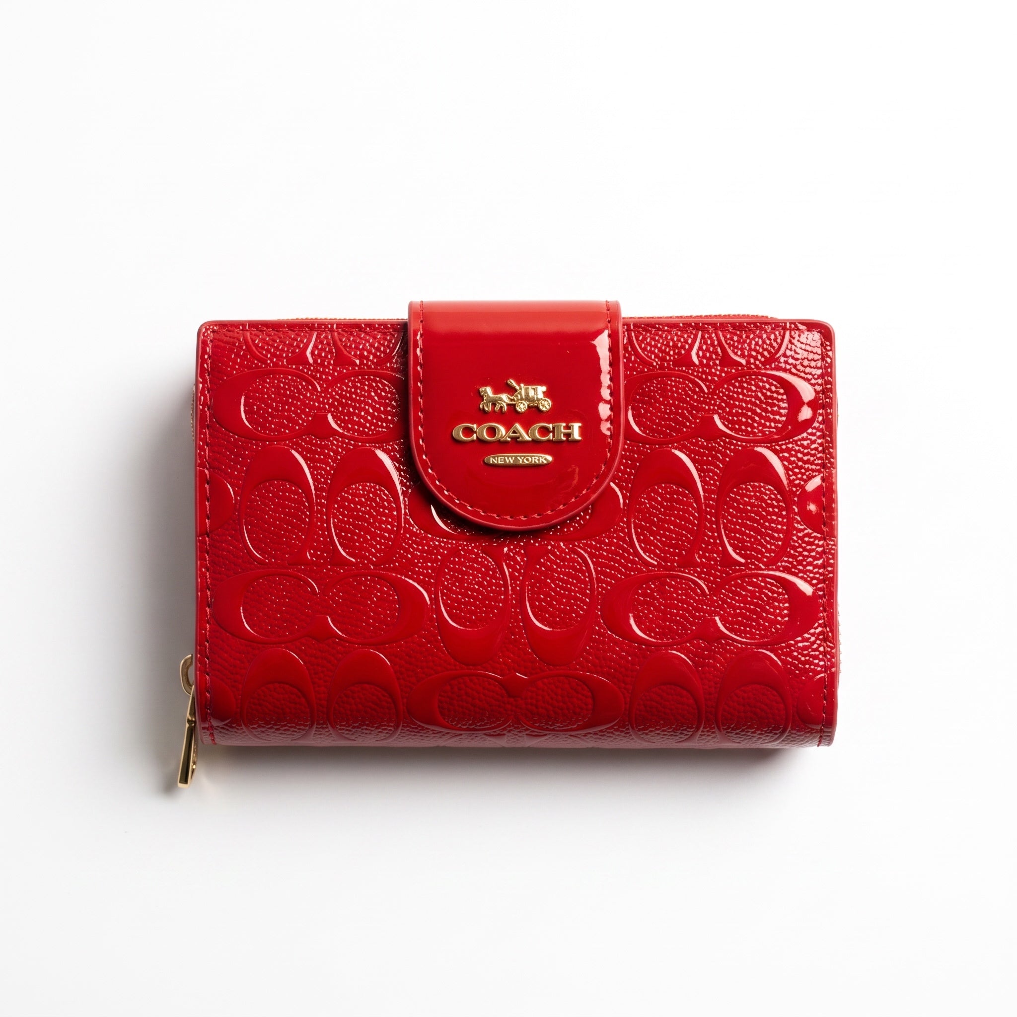 Red Coach mini wallet with embossed signature pattern and gold logo