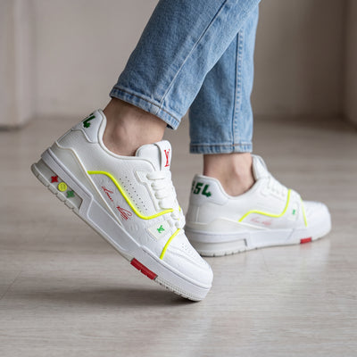 White Louis Vuitton low-top sneakers with neon yellow trim and embossed monogram