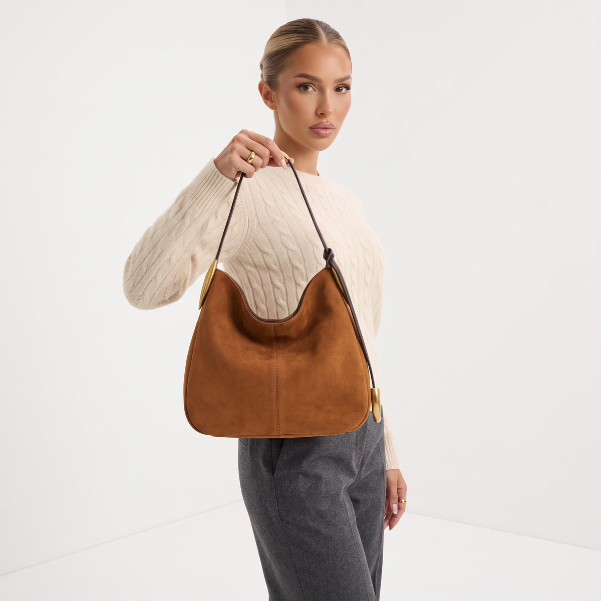 tan hobo bag with gold crescent hardware and single shoulder strap