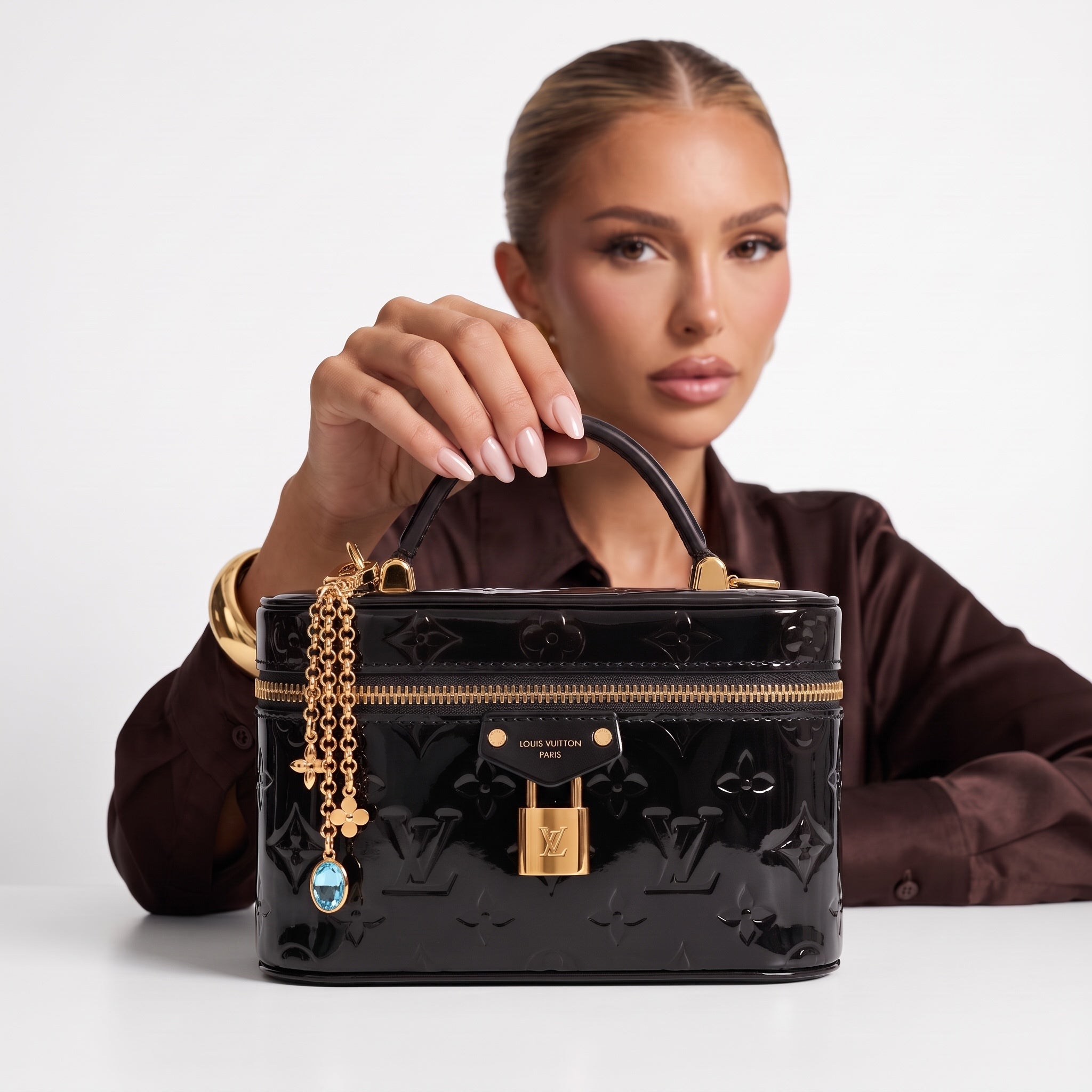 Black Louis Vuitton patent monogram vanity case with gold lock and charm chain
