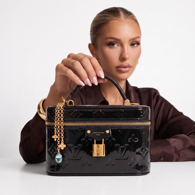 Black Louis Vuitton patent monogram vanity case with gold lock and charm chain