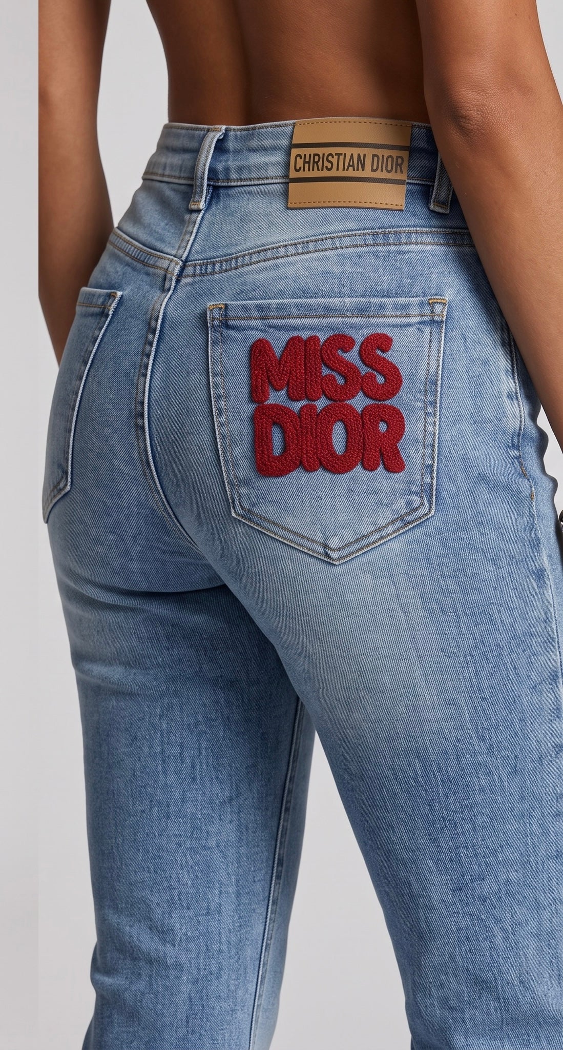 Light blue Christian Dior jeans with red MISS DIOR pocket embroidery and bee detail
