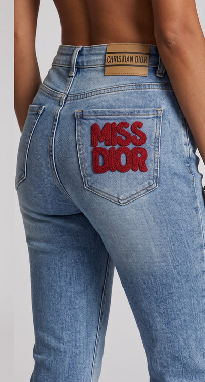 Light blue Christian Dior jeans with red MISS DIOR pocket embroidery and bee detail