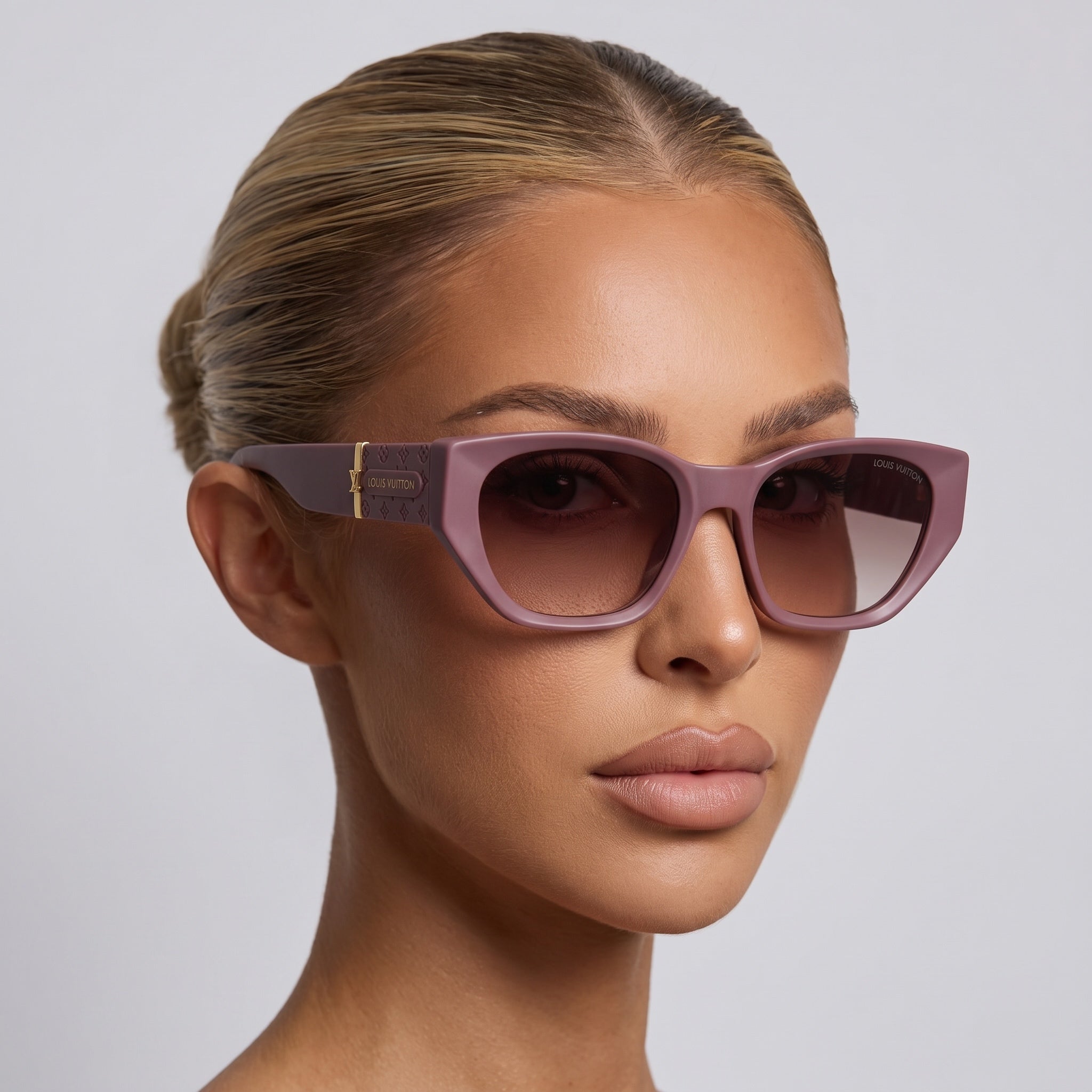 Close-up of mauve Louis Vuitton square sunglasses with logo plaque on temple