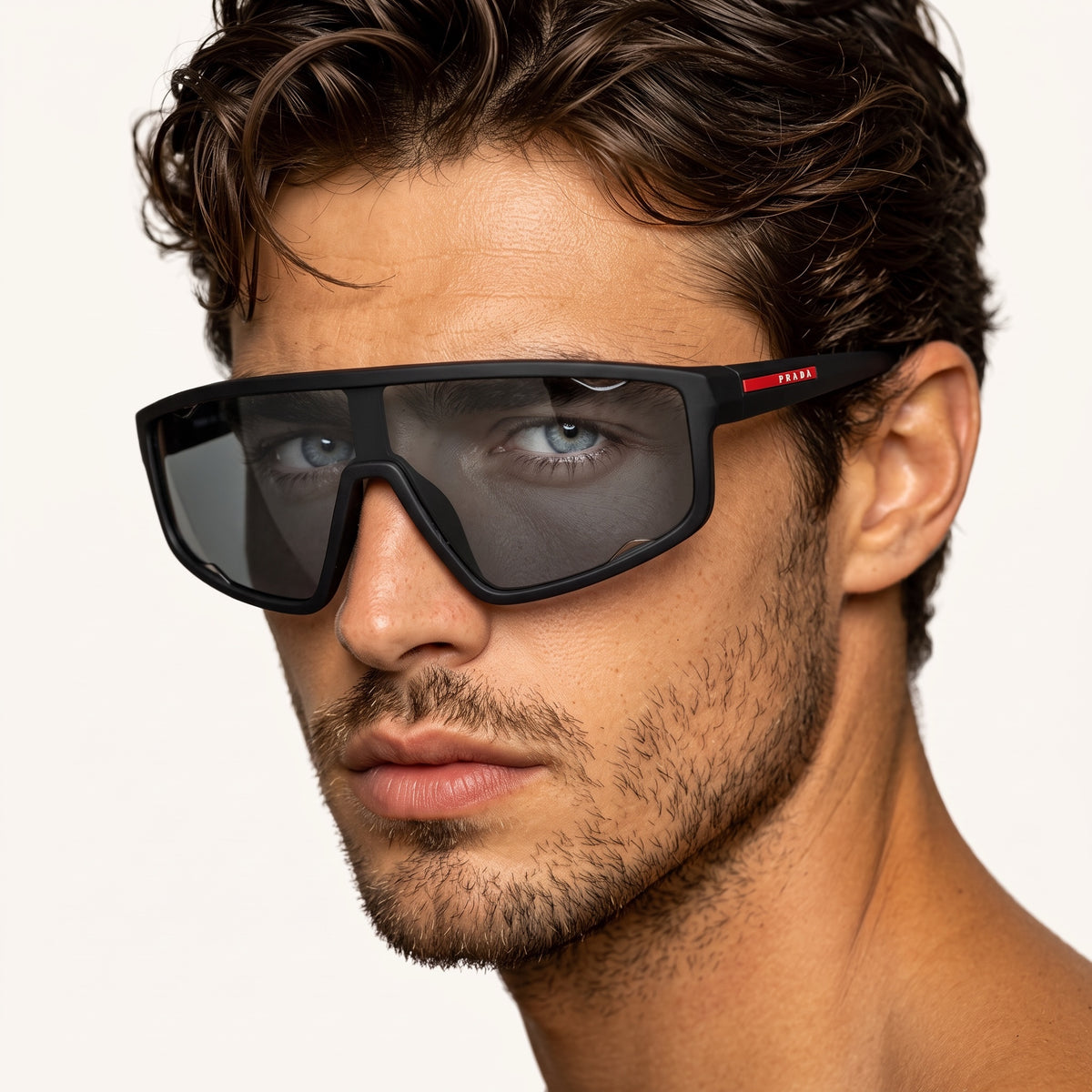 Prada matte black shield sunglasses with red logo plaque and polarized lens