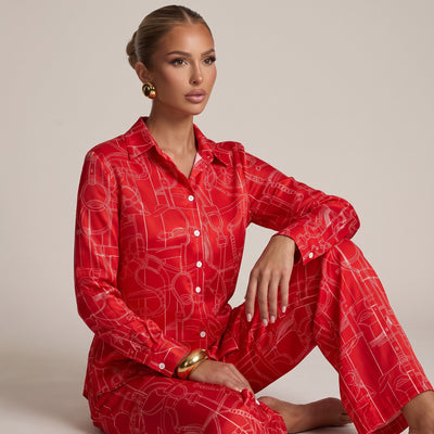 Red long-sleeve button-up shirt with white equestrian line print