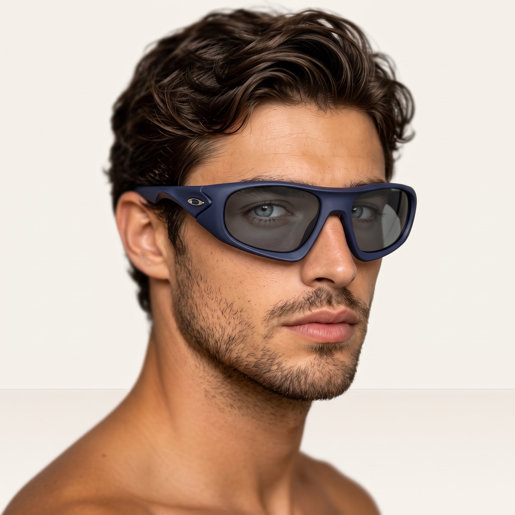close-up of man wearing matte navy Oakley sunglasses with dark lenses