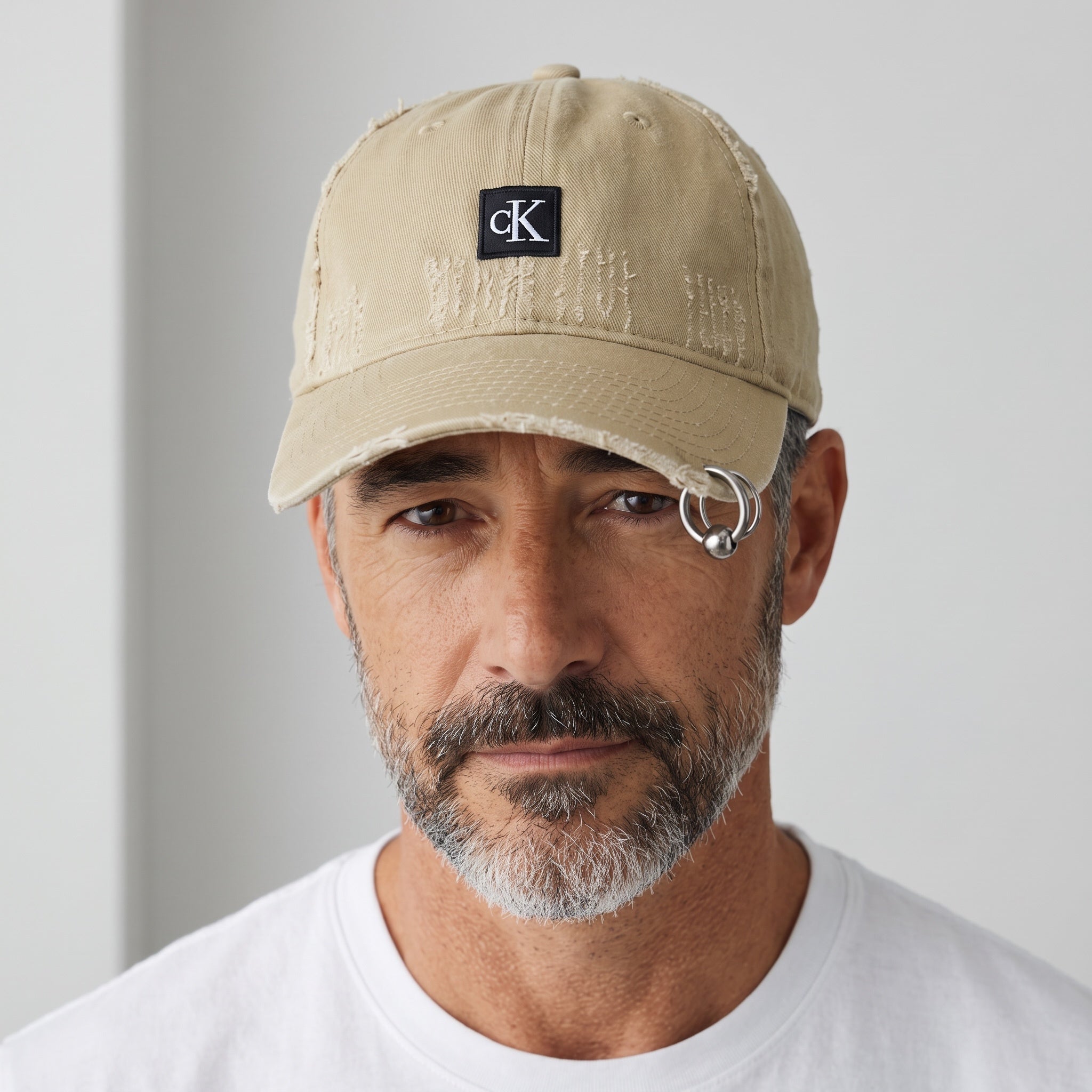 Man wearing a khaki distressed Calvin Klein CK baseball cap