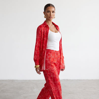Red long-sleeve button-up shirt with white equestrian line print