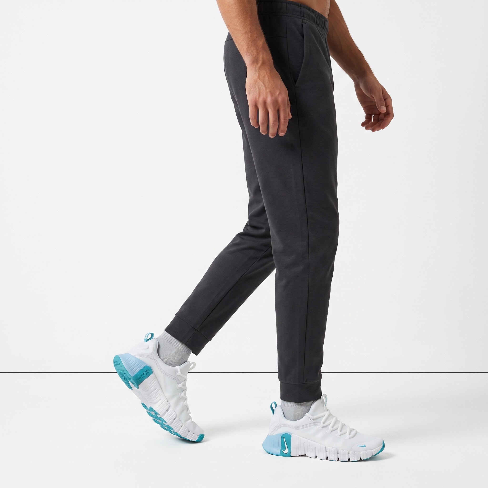 white Nike sneakers with teal accents and segmented sole