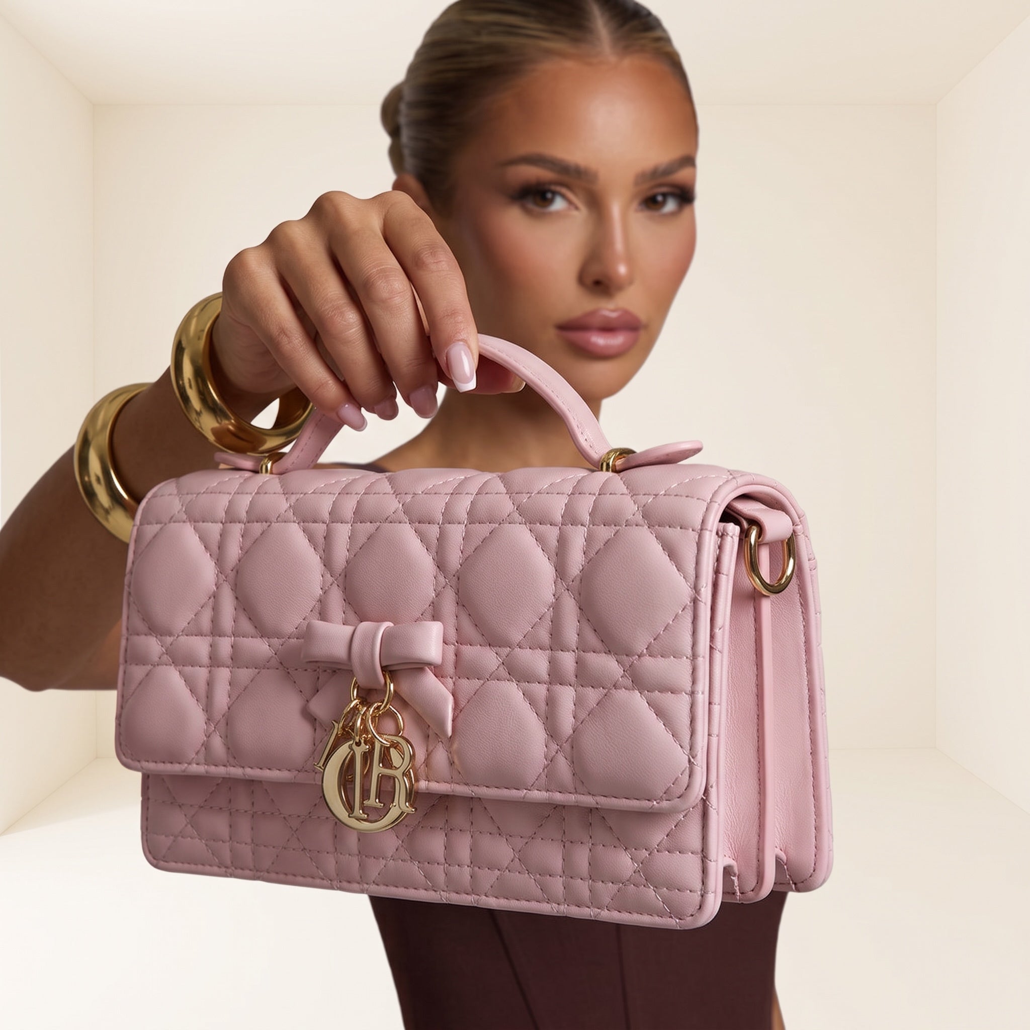 pink quilted Dior Lady top-handle bag with bow and gold logo charm