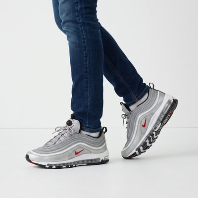 Silver Nike Air Max 97 sneakers with visible Air unit and red Swoosh