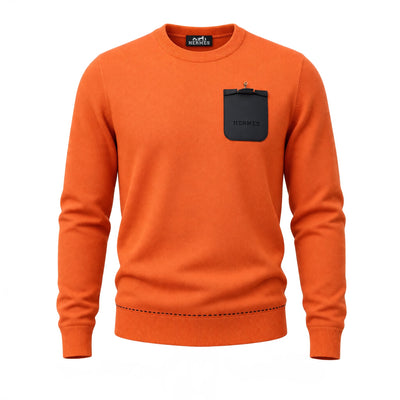 Hermès orange crewneck sweater with black embossed pouch and gold clasp on chest
