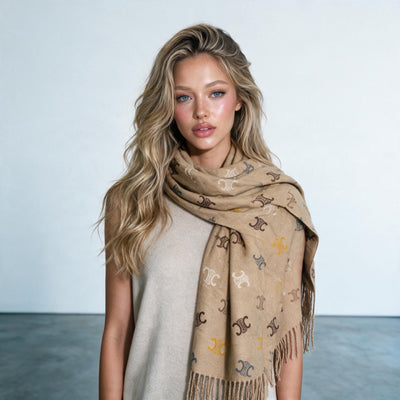 camel coloured scarf with repeating Triomphe monogram motif and fringed ends wrapped around model
