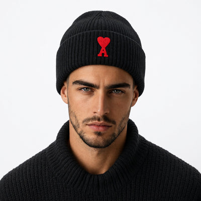 Black ribbed cuffed beanie with red heart and A logo embroidered on front