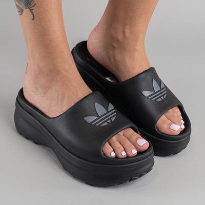black adidas platform slide sandal with embossed trefoil