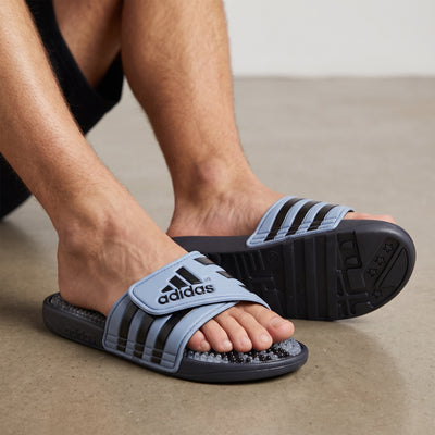 Adidas light blue and black three-stripe massage slides with beaded footbed