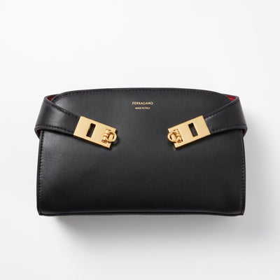 Black Ferragamo small flap bag with gold hardware and red trim