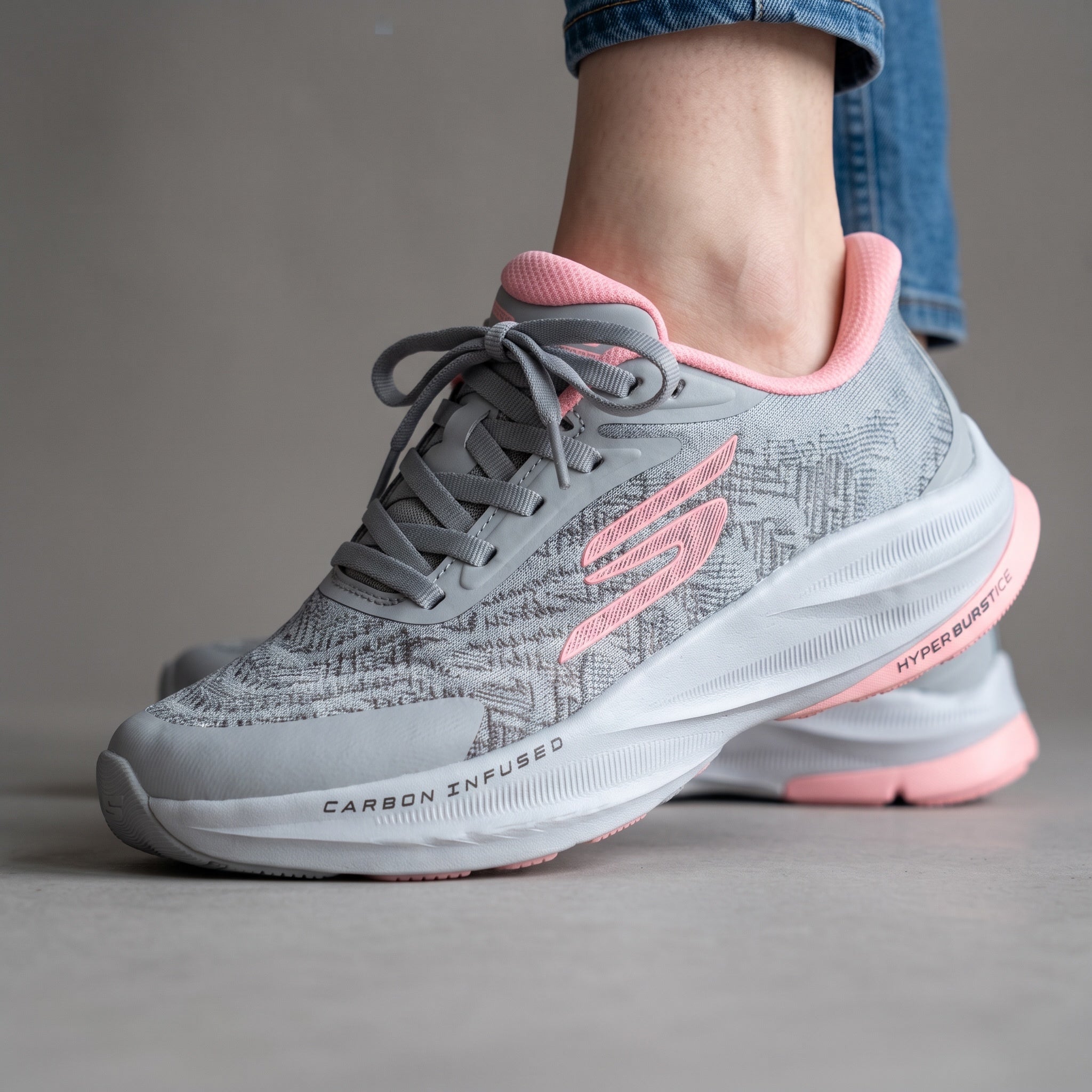 grey Skechers running sneaker with pink accents and chunky white midsole