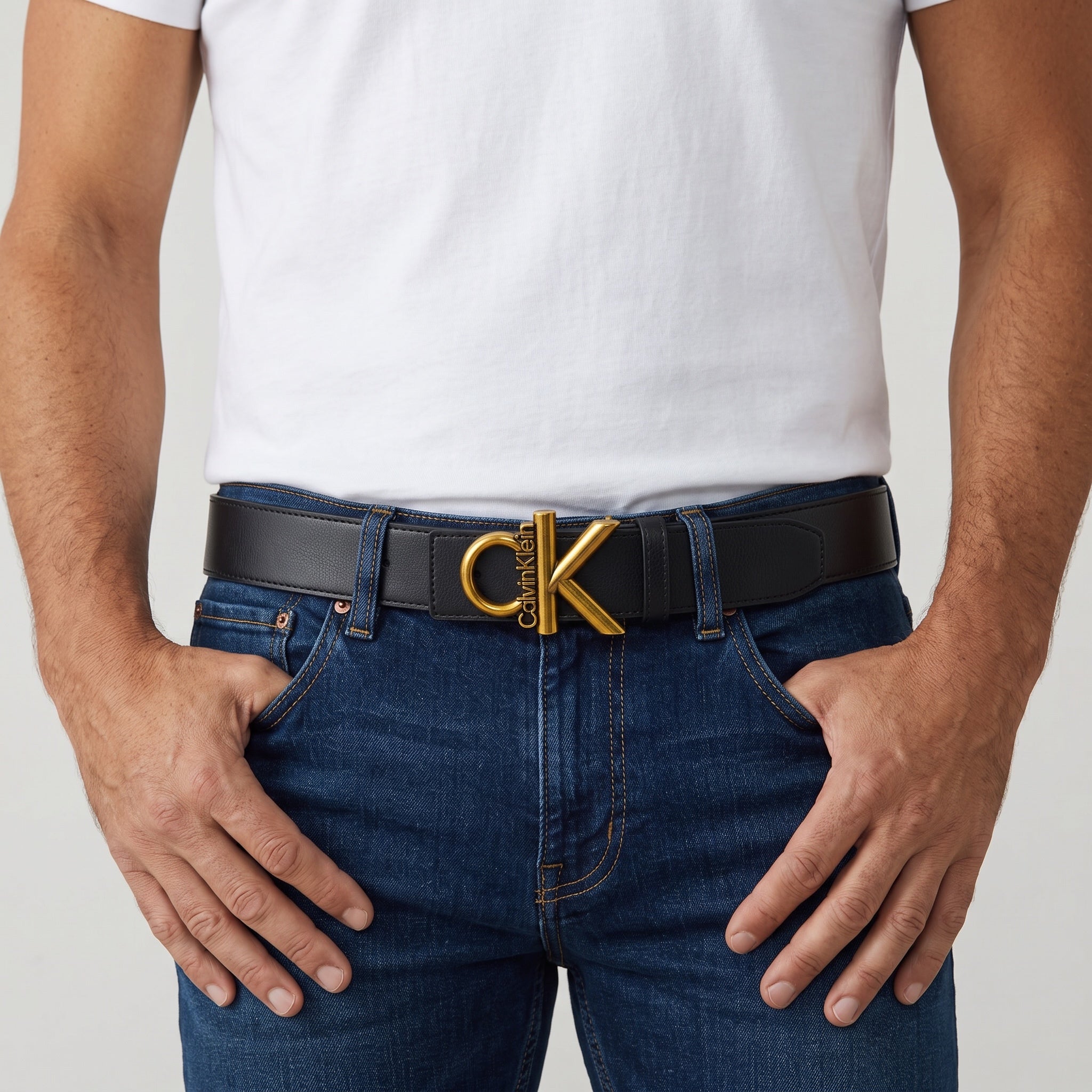 Calvin Klein black belt with gold CK logo buckle worn at waist