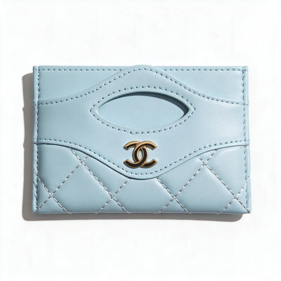 Light blue quilted Chanel card holder with gold CC logo