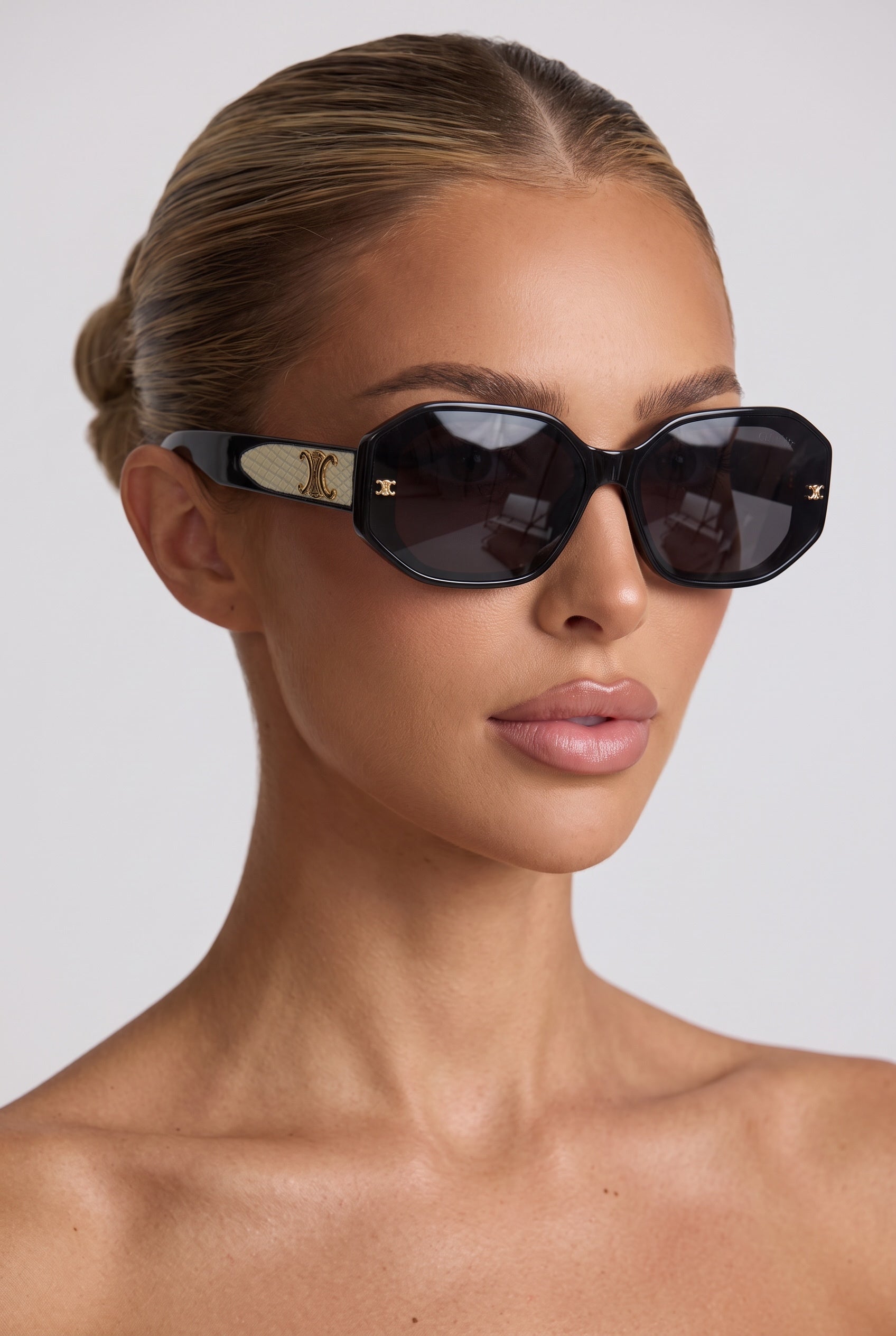 Black Celine octagon sunglasses with gold Triomphe logo on temples and dark lenses