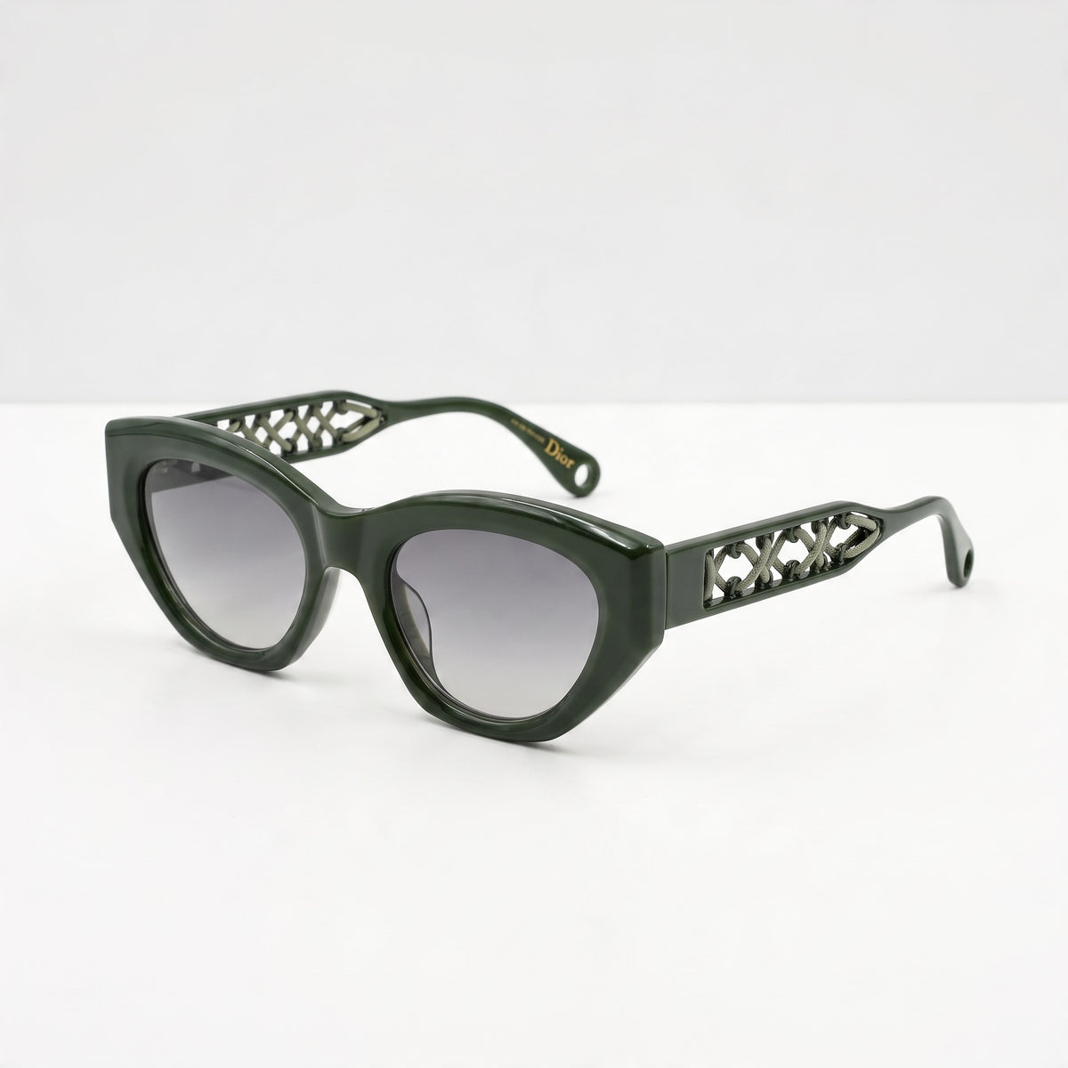Olive green Dior cat-eye sunglasses with cutout lattice temples and gradient lenses