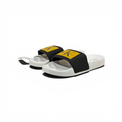 CALVIN KLEIN Luxury Black & White Slide Sandals – Yellow CK Logo Patch & Modern Street Style 👟✨