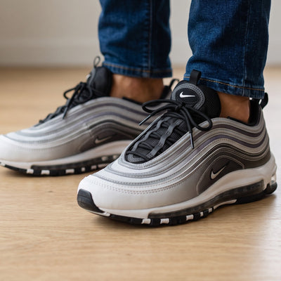 Nike Air Max 97 sneaker in silver, black and white showing wavy upper and full-length Air unit