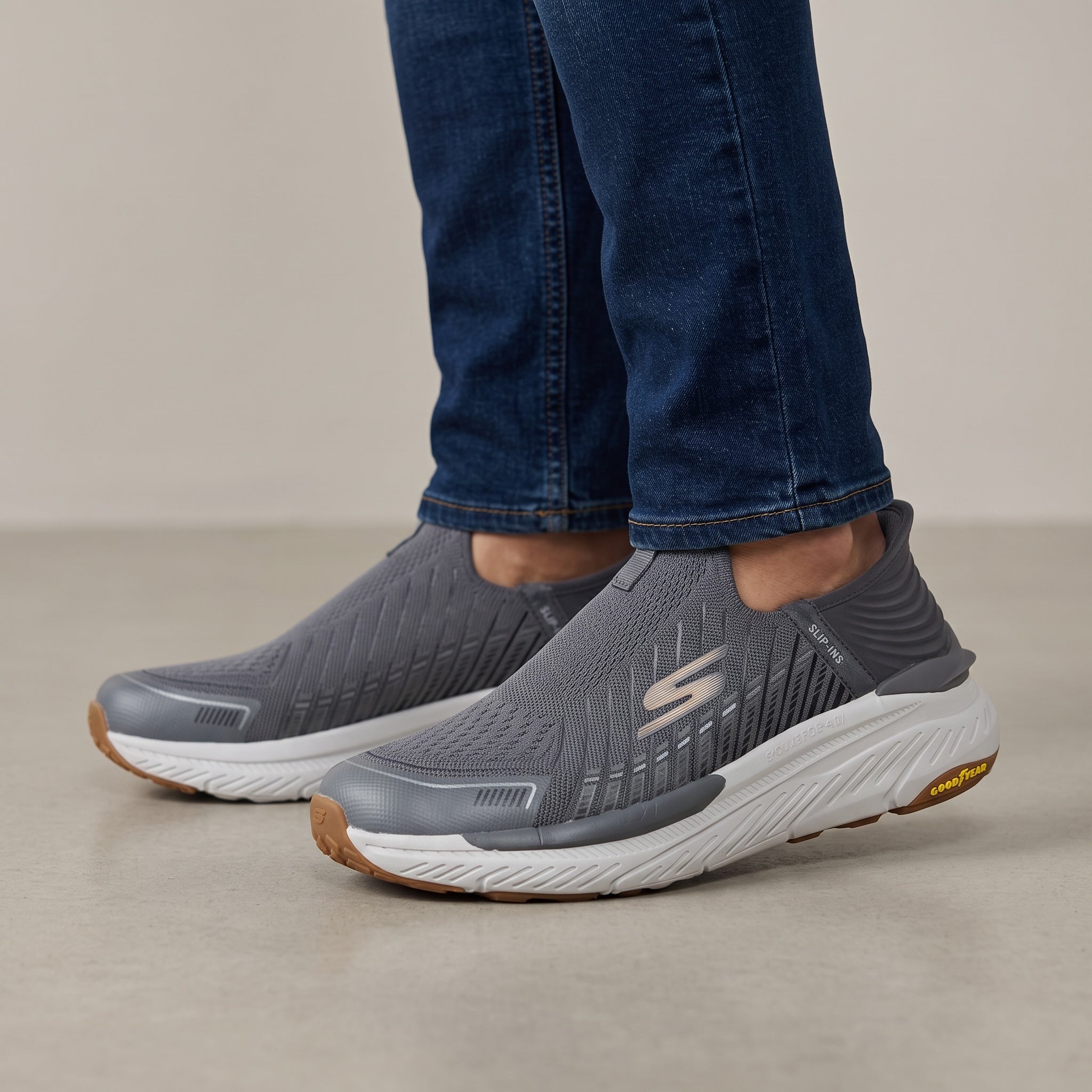 Grey Skechers slip-on knit trainer with white midsole and Goodyear gum outsole