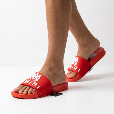 Red Amiri logo slide sandal on model feet