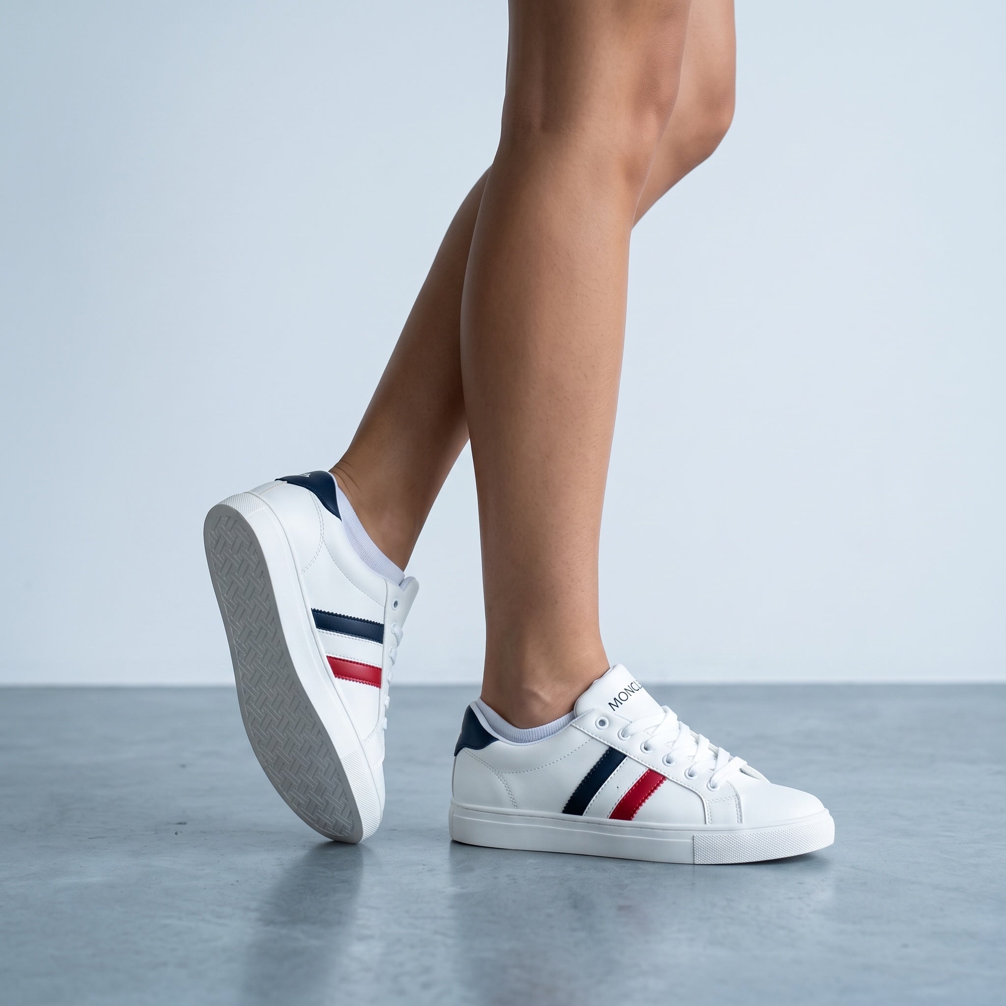 White Moncler low-top sneakers with navy and red side stripes