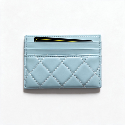 Light blue quilted Chanel card holder with gold CC logo