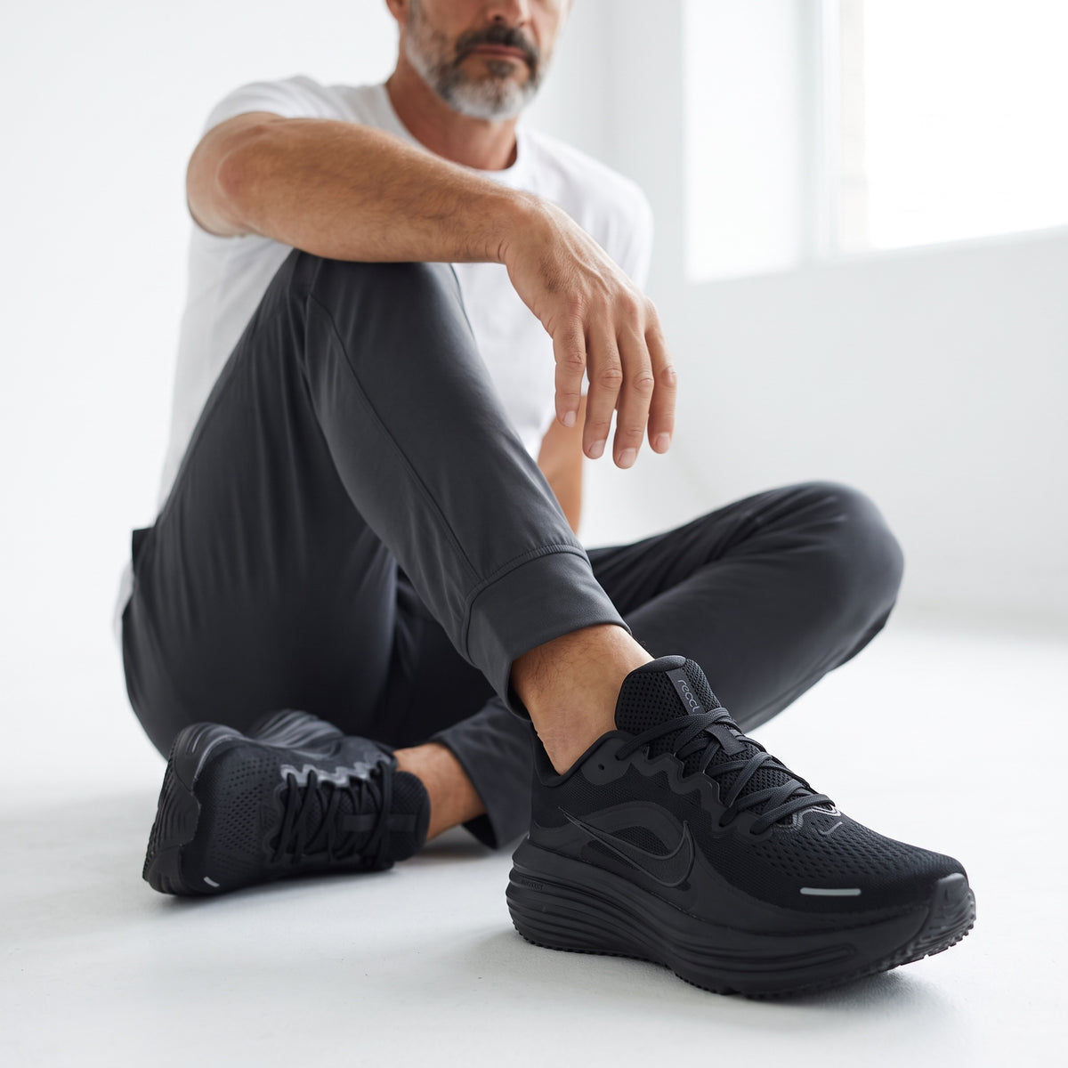 black Nike low-top athletic sneakers with mesh upper and chunky sole