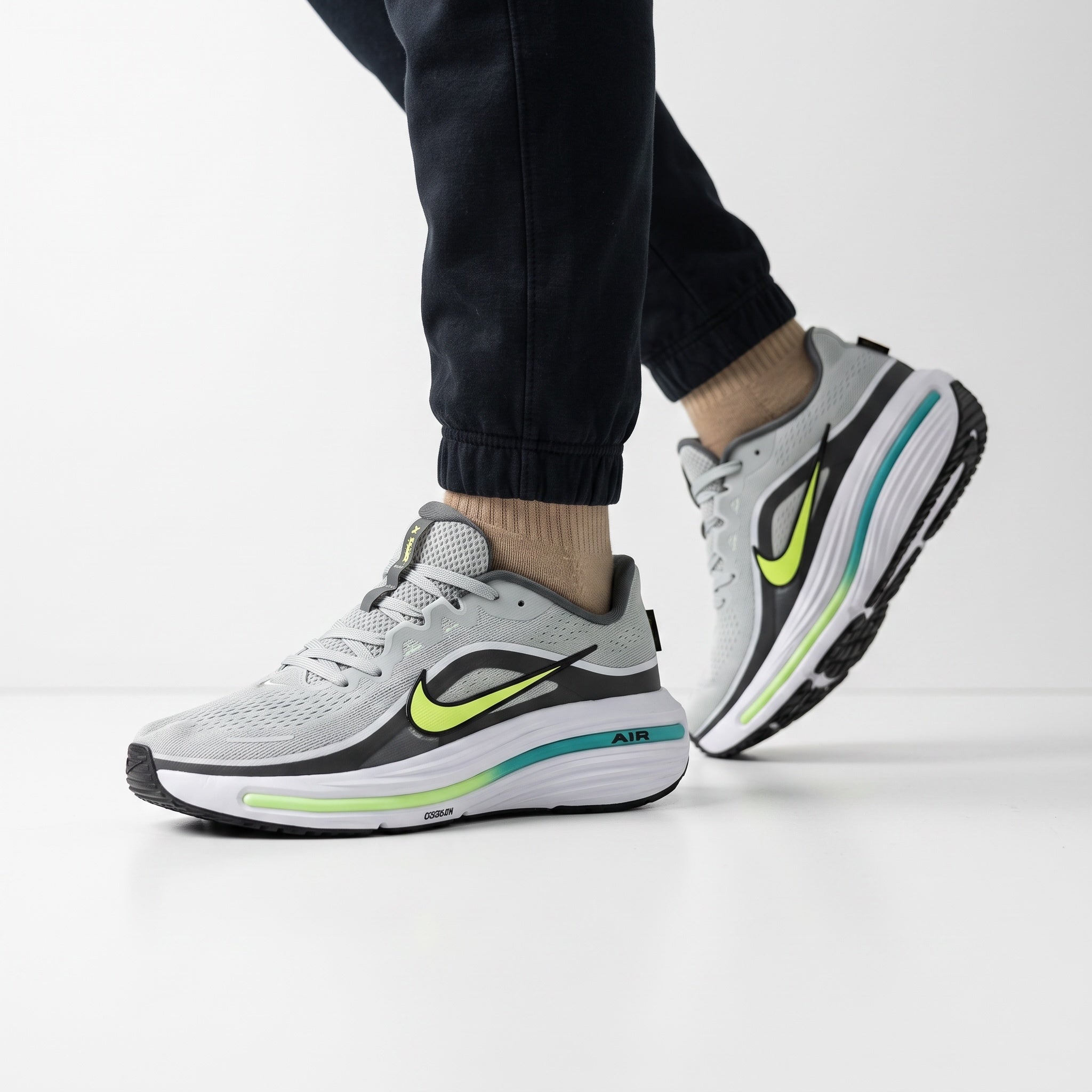 Grey Nike running sneakers with neon lime Swoosh and teal midsole accents