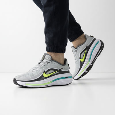 Grey Nike running sneakers with neon lime Swoosh and teal midsole accents