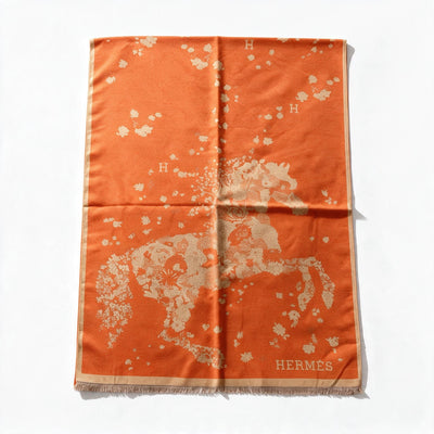 Orange Hermès scarf with floral motif, "H" logo and fringed edges