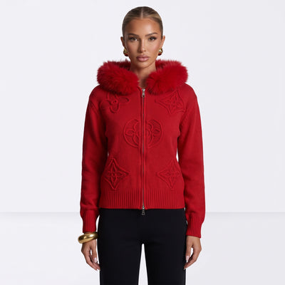 Red zip-up knit hoodie with fur-trim hood and raised decorative motifs