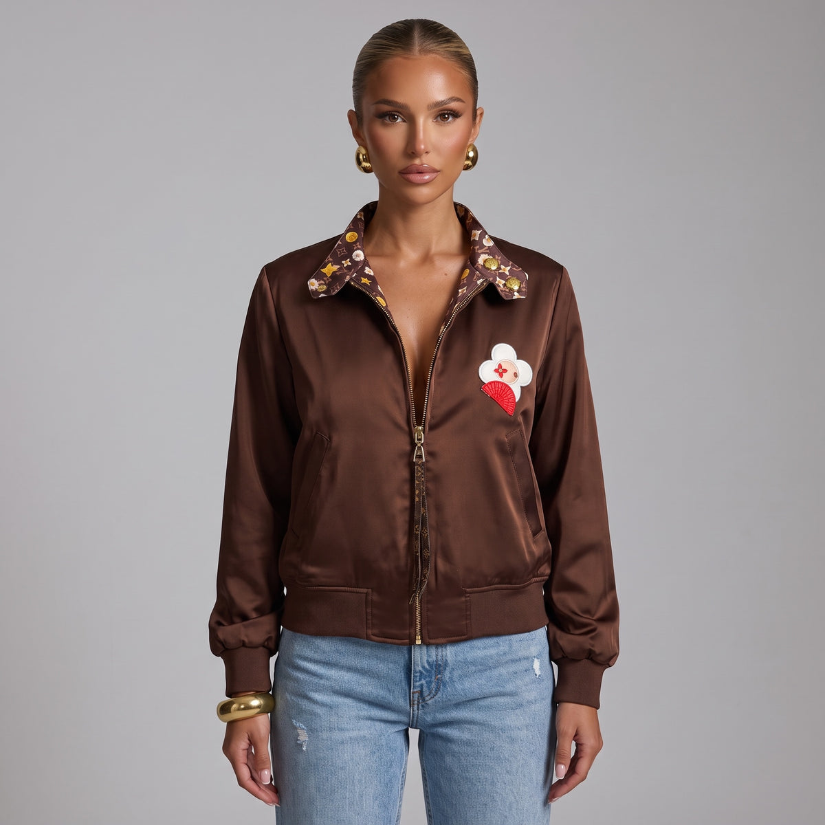 brown reversible bomber jacket with monogram floral print and gold zipper