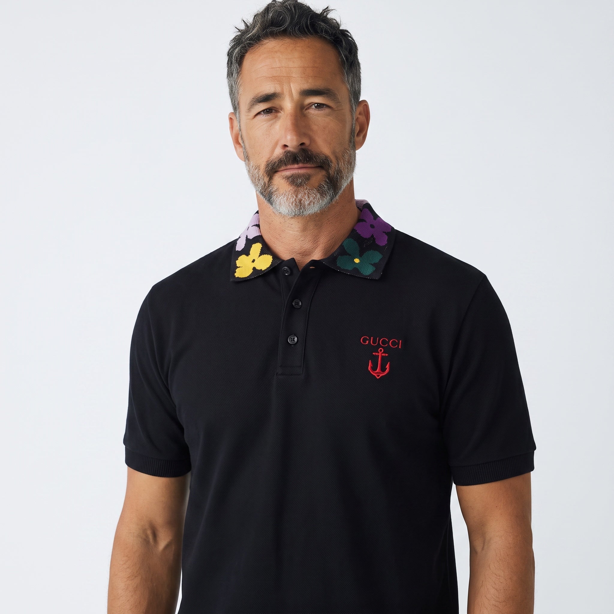 Black Gucci polo with multicolour floral knit collar and red embroidered logo