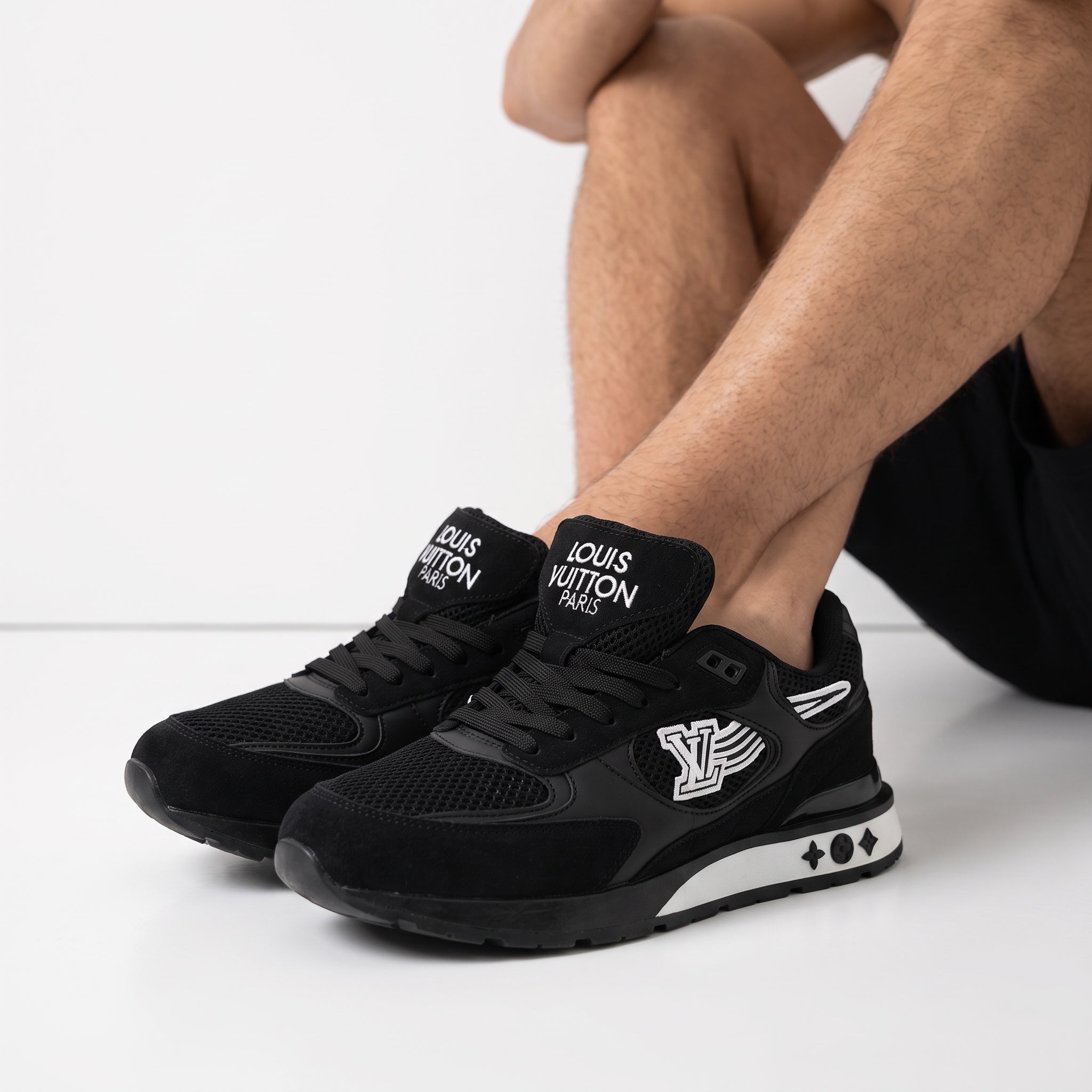 Black Louis Vuitton sneakers with LV wing logo and monogram midsole