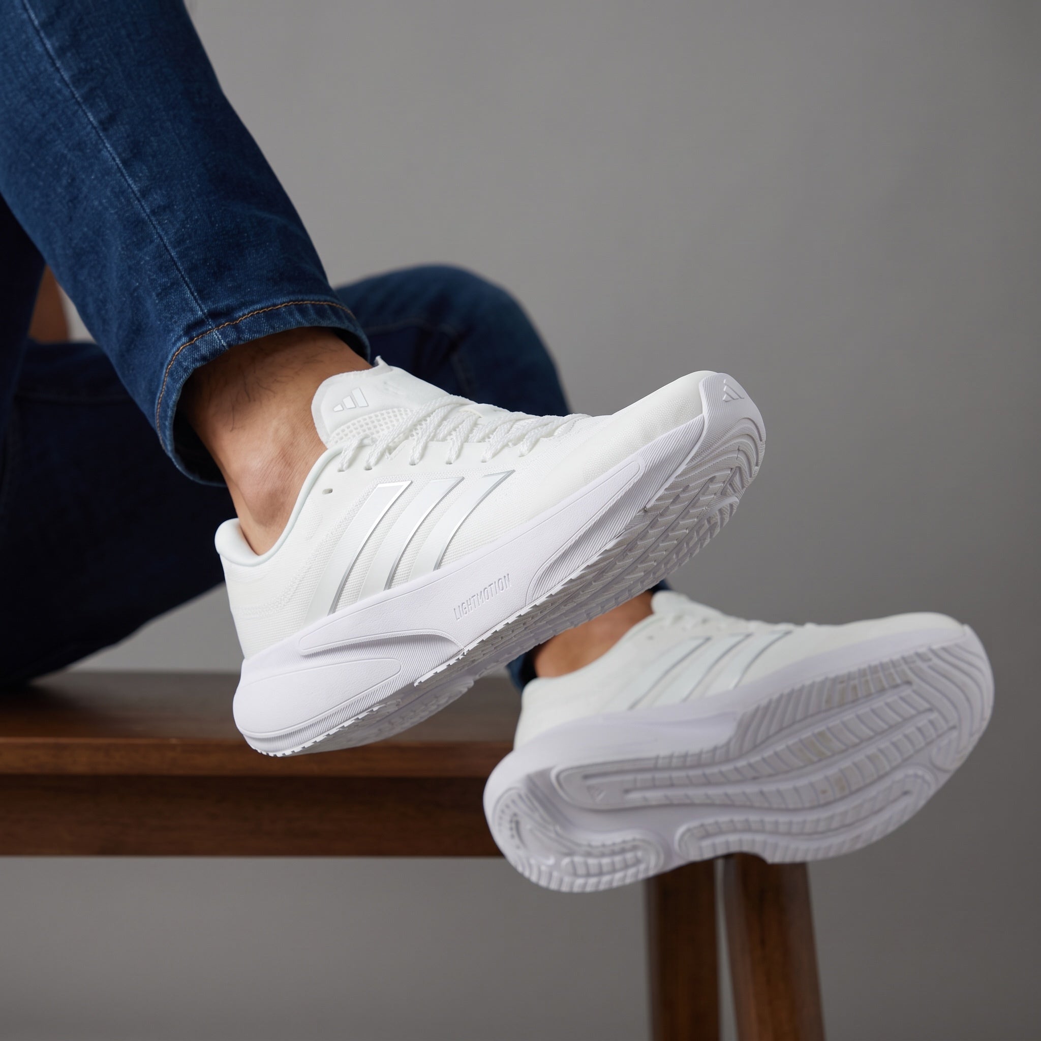 All‑white Adidas low-cut sneakers with chunky sole and three stripes