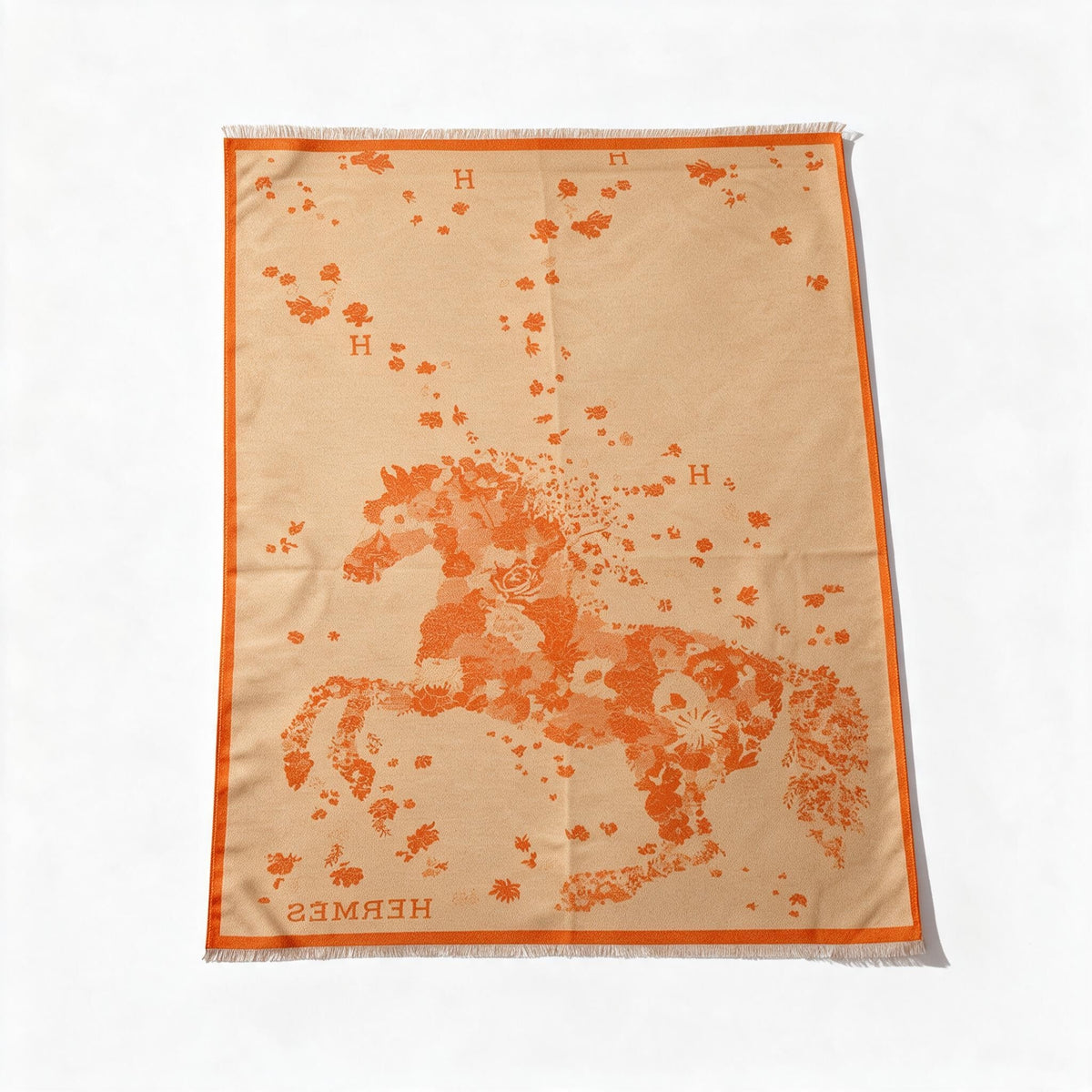 Orange Hermès scarf with floral motif, "H" logo and fringed edges
