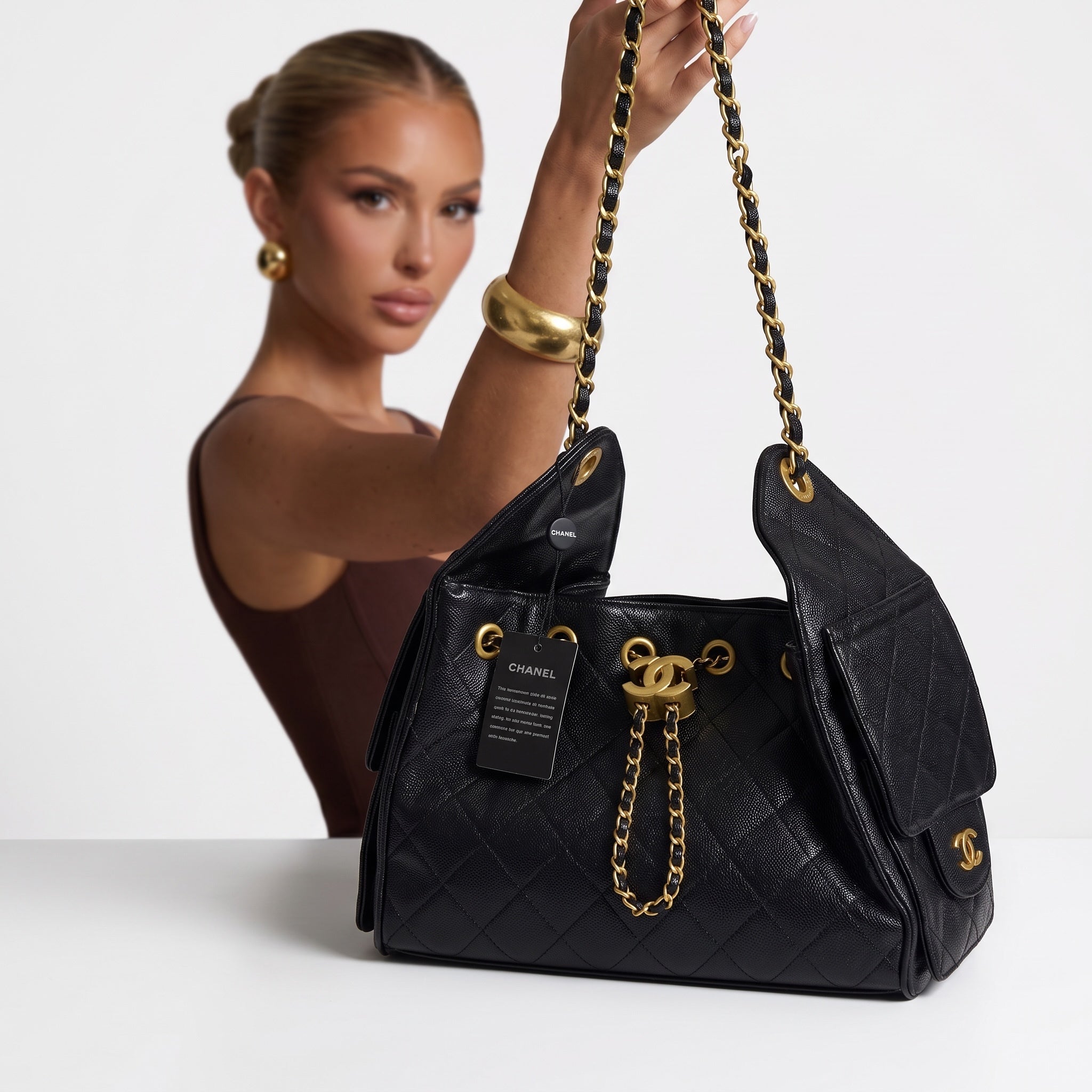 Black Chanel quilted shoulder bag with gold CC hardware and chain strap