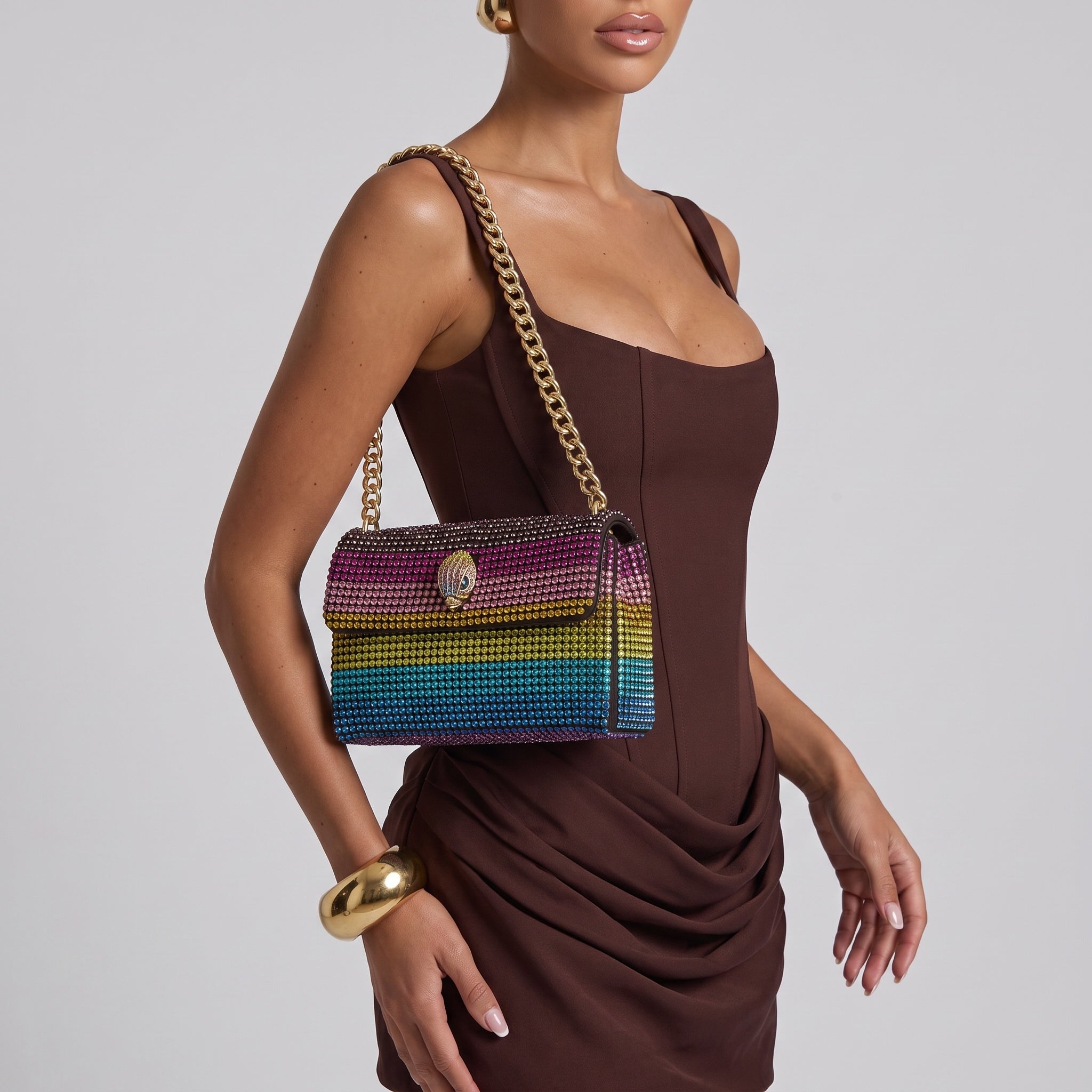 Rainbow crystal-studded shoulder bag with gold chain strap and decorative clasp