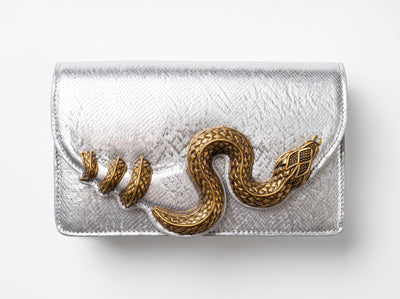silver textured clutch with gold snake embellishment