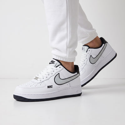 Nike Air Force 1 Low white sneaker with grey swoosh and black accents