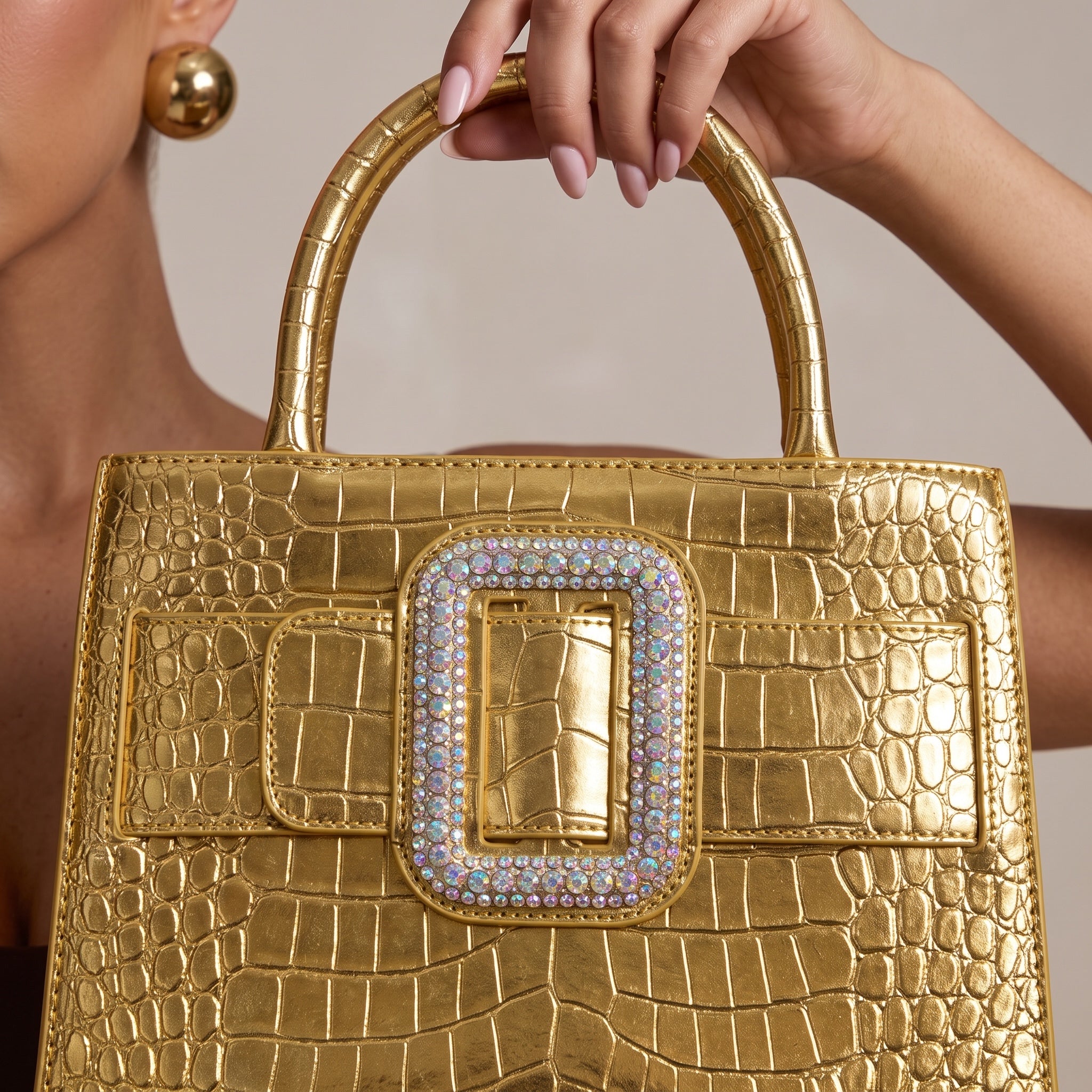 Gold croc-embossed Roger Vivier tote with crystal-embellished buckle and top handles